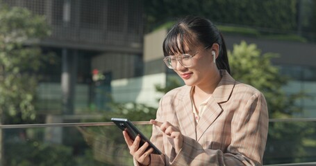 Asian teenage woman using smartphone to shop online. Women make financial transactions, transfer money via bank apps, order products. Businesswoman chatting on mobile phone. communication technology