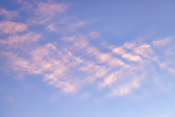 A beautiful sky tinted by the sun leaving vibrant shades of gold, pink, blue and multicolored. Clouds in the twilight evening and morning sky. Cloudy sky background in the evening, and during the day.