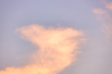 A beautiful sky tinted by the sun leaving vibrant shades of gold, pink, blue and multicolored. Clouds in the twilight evening and morning sky. Cloudy sky background in the evening, and during the day.