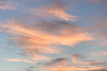 A beautiful sky tinted by the sun leaving vibrant shades of gold, pink, blue and multicolored. Clouds in the twilight evening and morning sky. Cloudy sky background in the evening, and during the day.