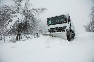 Snow plow removing snow from street.