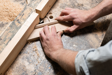 A carpenter is milling an oak corner piece