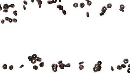 Chocolate rings cereal spill out into a bowl. Breakfast.