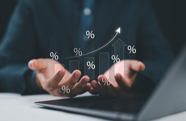 Hand holding graph with percentage, special offer of shopping department store discount and tax concept, adjusting interest rates, raising interest rates to fight inflation, returns on investments.