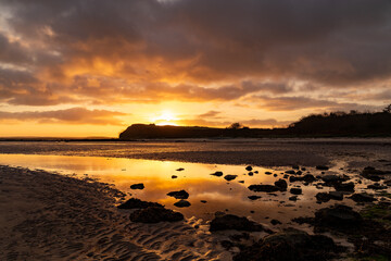 Sunset at Trearddur Bay with a lifeboat returning 