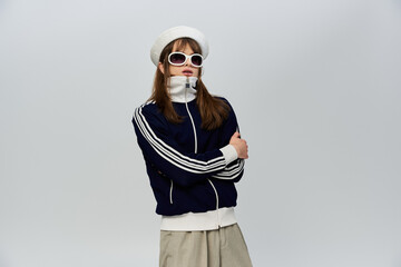 A young man showcases his unique style with a trendy outfit and striking accessories.