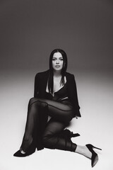 Stylish, luxurious photo shoot of a beautiful girl in a jacket and without in a photo studio in fashion and Vogue style.