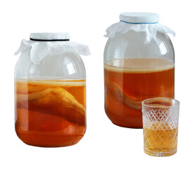 Homemade kombucha, fermented tea with a scoby inside glass jars, and a glass of kombucha tea, isolated on a white background