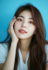 A beautiful Korean woman in her twenties with long hair, wearing white and posing for the camera.