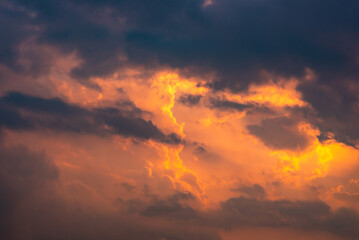 Dramatic sunrise and sundown sky background with gentle colorful clouds.
