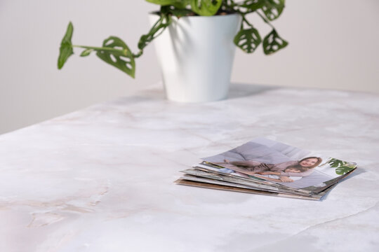 woman sitting at desk and looking at printed photos, remember nostalgia for a day of rest. photography cards, background. Mock up