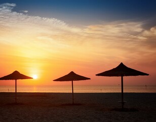 A sunset on the beach with tents