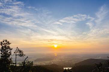 The beautiful landscape of the sunrise, The sun's rays through the clouds at the top of the hill and the Rice fields Faint fog, Phayao Northern Thailand