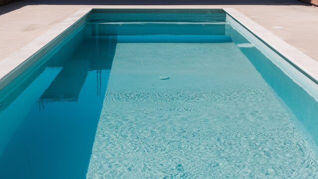 Pristine empty pool with reflective water and imma