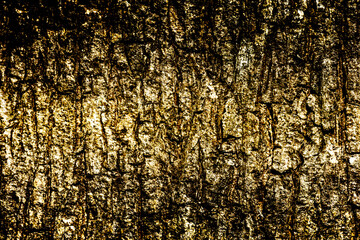 Dramatic abstract textured background in shades of gold and black.