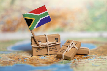 South African International Shipping: Small Packages and Parcels on World Map with National Flag...