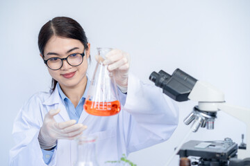 Fototapeta premium The female scientist with a test tube