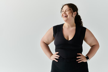A beautiful plus size woman stands confidently, radiating joy in a chic, minimalistic environment.