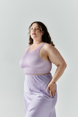 Obraz premium A beautiful plus size woman showcases her confidence and style in a chic lavender ensemble.