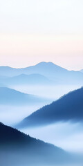 Obraz premium Serene morning mountains with misty valleys and soft blue hues
