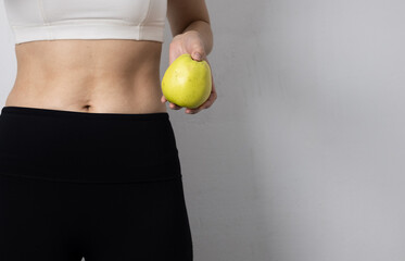 A woman's waist and apple symbolize healthy living. Promoting healthy eating