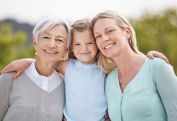 Obraz premium Smile, portrait and generations with women, girl and hug in nature, park and summer for holiday. Happy, love and mom embracing children with care for vacation, adventure or weekend break for family