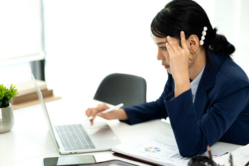 young businesswoman Wearing a suit bending over the table
