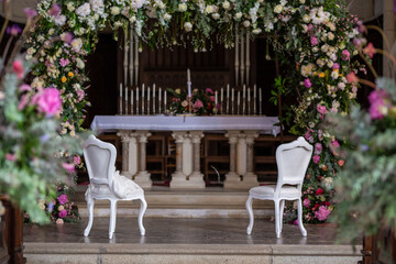 Elegant Wedding Altar with Floral Arch and White Chairs
