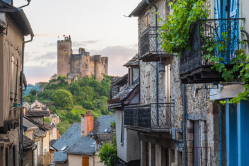 Main street in Najac village with views of the emerging medieval castle, France
