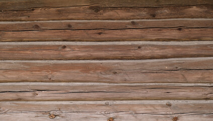 Fototapeta premium Old wooden log wall of a house. Close-up. Background. Texture.