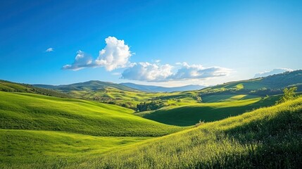 Rolling Green Hills Under a Blue Sky with Puffy White Clouds