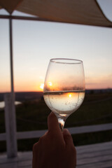 Glasses of wine against red sunset