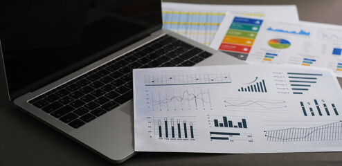 analyzing income charts and graphs with modern laptop computer. Business analysis and strategy concept.