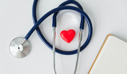 The concept of family insurance and medical care. a stethoscope and a heart figurine