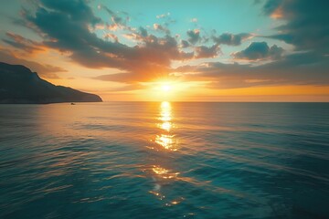 Obraz premium Serene sunset over calm waters with distant mountains.