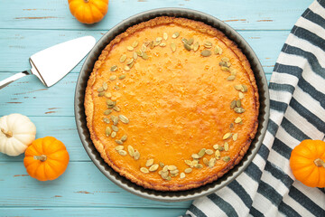 American Pumpkin Pie for autumn holiday on blue wooden background. Happy Thanksgiving Day. Top view