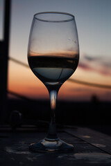 Glasses of wine against red sunset