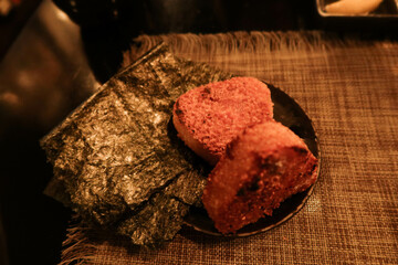 close up of Japanese grilled crispy rice onigiri rice ball with seaweed
