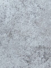 A grey and white wall with a few spots of color