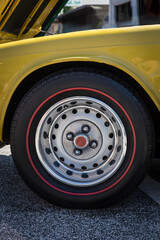 A yellow vintage car tire and fender.