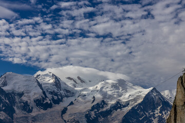 Mont Blanc, Monte Bianco mountain summit snow dome above the Chamonix valley in France. Highest peak in Europe in the Alps, alpice scenic view of Montblanc