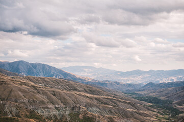 Fototapeta premium Majestic mountains of Armenia under a blue sky filled with clouds, showcasing natural beauty