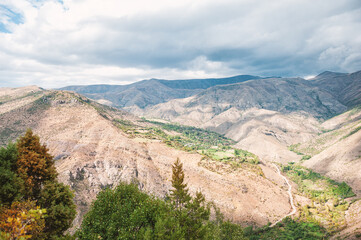 Majestic mountains of Armenia under a blue sky filled with clouds, showcasing natural beauty