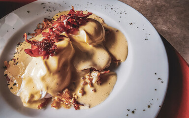 Meal in the restaurant white plate with egg breakfast melba.