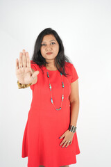 Portrait of gorgeous confident girl in red short gesturing blurred palm front, stop sign fighting with violence isolated on white background stock photo