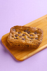 Cookies on wood with a lilac background