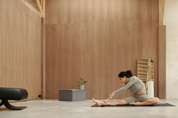 Practicing Yoga in Minimalistic Wooden Studio