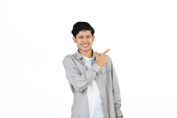 Young Teenager in shirt and vest gives expression of happiness and sadness points with gestures with hands