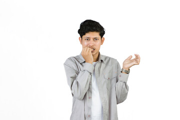 Young Teenager in shirt and vest gives expression of happiness and sadness points with gestures with hands