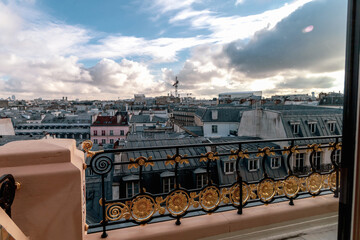 View to the roofs of buildings in Paris and the sky with clouds, France